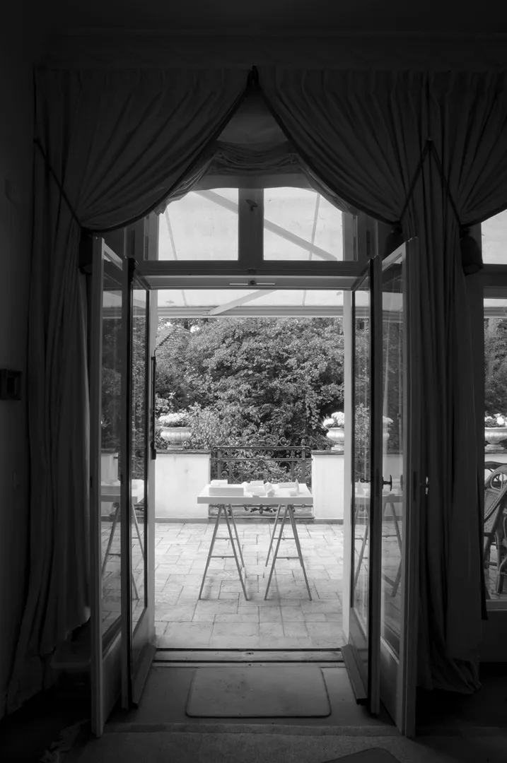 physical model on trestles on terrace viewed through terrace doors